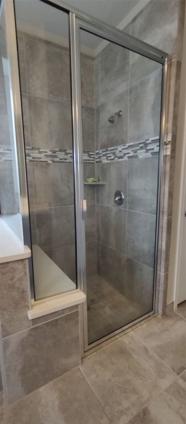 bathroom featuring tile patterned flooring and walk in shower