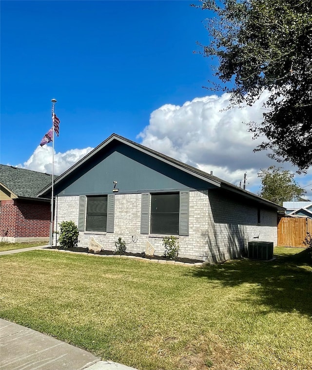 view of property exterior with a yard and central AC unit