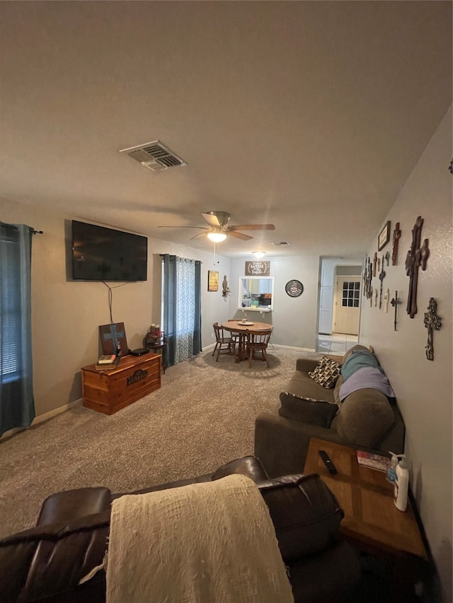 living room featuring carpet flooring and ceiling fan