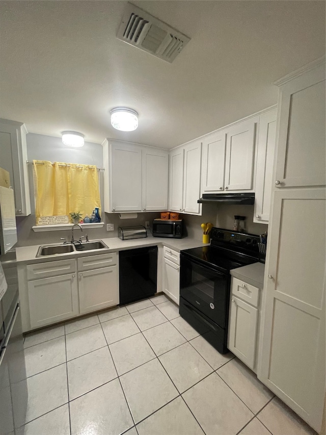 kitchen with white cabinets, black appliances, sink, and light tile patterned floors