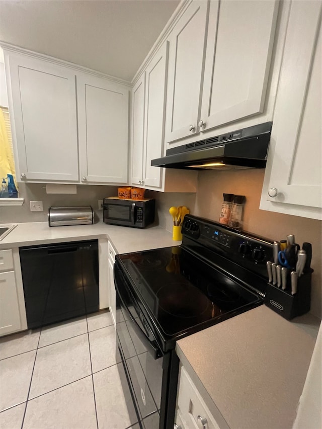 kitchen with white cabinetry, black appliances, and light tile patterned flooring