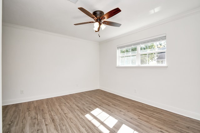 spare room featuring light hardwood / wood-style floors, ceiling fan, and ornamental molding