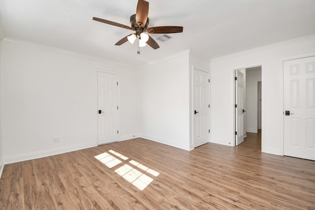 spare room with crown molding, ceiling fan, and light hardwood / wood-style floors