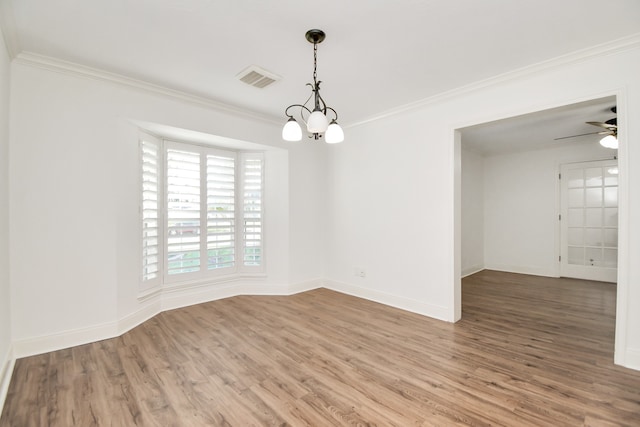 spare room with hardwood / wood-style floors, ceiling fan with notable chandelier, and ornamental molding