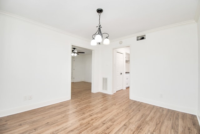 empty room featuring a chandelier, light hardwood / wood-style flooring, and ornamental molding