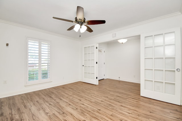 spare room featuring french doors, light hardwood / wood-style floors, ceiling fan, and ornamental molding