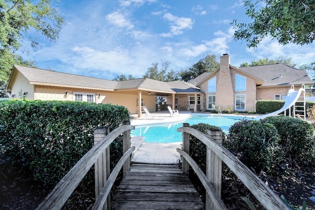 view of pool with a patio and a water slide