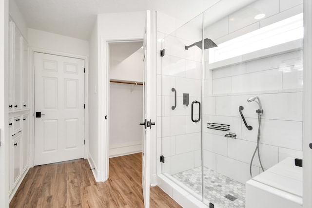 bathroom featuring wood-type flooring and walk in shower