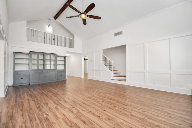 unfurnished living room featuring beam ceiling, hardwood / wood-style flooring, high vaulted ceiling, and ceiling fan