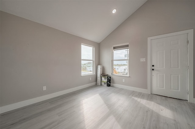 interior space with high vaulted ceiling and light hardwood / wood-style flooring