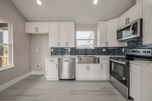 kitchen with white cabinetry, a healthy amount of sunlight, and appliances with stainless steel finishes