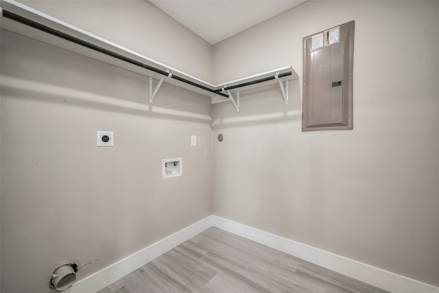 laundry room with light hardwood / wood-style floors, washer hookup, electric dryer hookup, gas dryer hookup, and electric panel