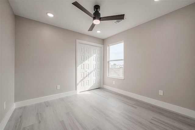 unfurnished bedroom featuring a closet, ceiling fan, and light hardwood / wood-style flooring