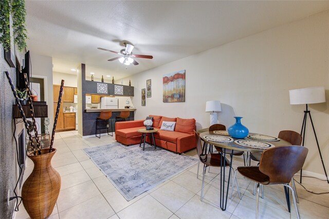 tiled living room featuring ceiling fan