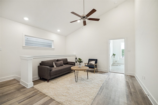 living room featuring hardwood / wood-style floors, high vaulted ceiling, and ceiling fan