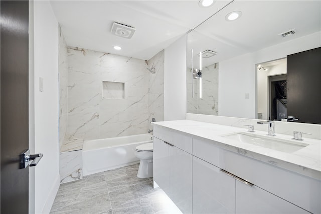 full bathroom with vanity, toilet, and tiled shower / bath