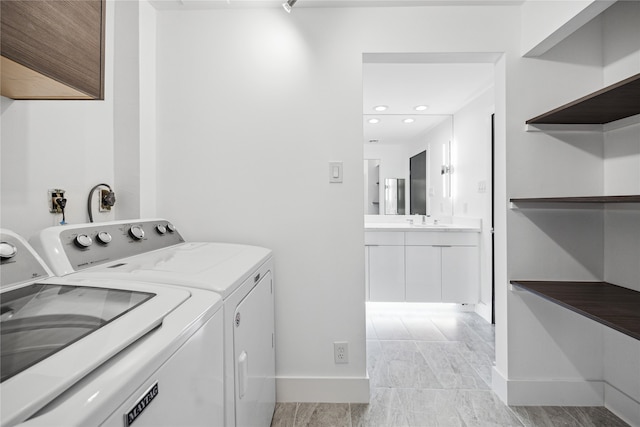 clothes washing area featuring sink and washing machine and dryer