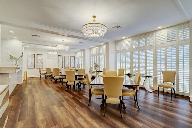 dining area with dark wood-type flooring, ornamental molding, and an inviting chandelier