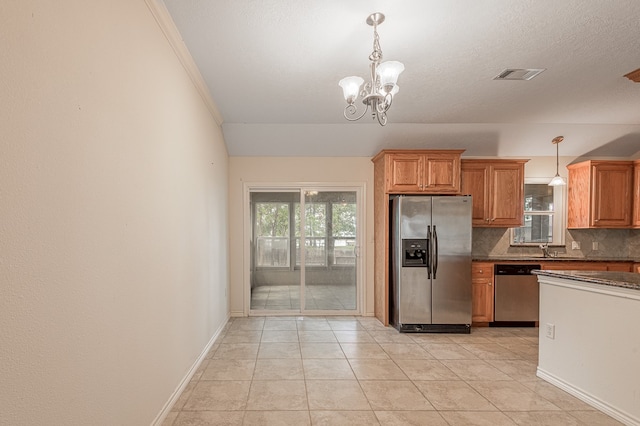 kitchen featuring stainless steel appliances, tasteful backsplash, decorative light fixtures, and an inviting chandelier