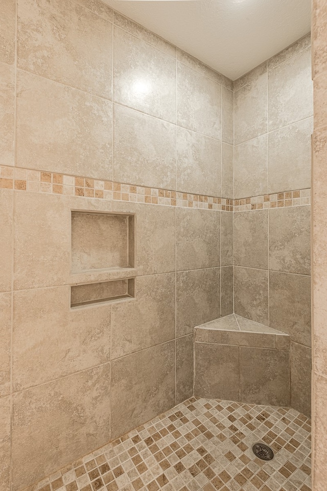 bathroom with tiled shower