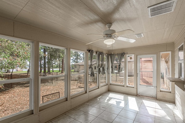 unfurnished sunroom featuring ceiling fan