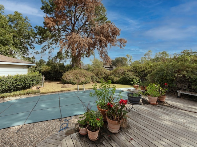 view of pool with a wooden deck and a patio