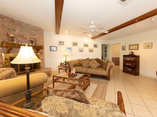 living room featuring a large fireplace, beamed ceiling, light tile patterned flooring, and ceiling fan