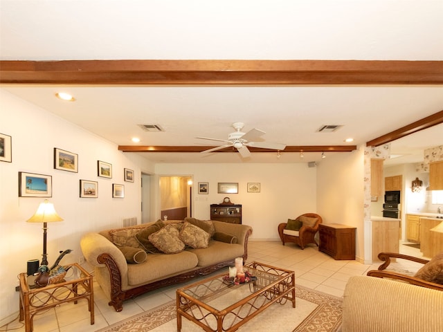 living room featuring beam ceiling, ceiling fan, and light tile patterned floors