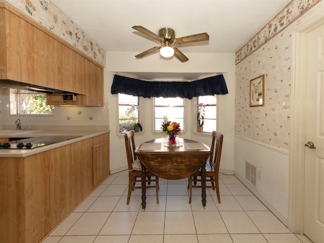 tiled dining area featuring ceiling fan