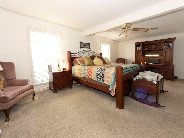 carpeted bedroom featuring beamed ceiling and ceiling fan