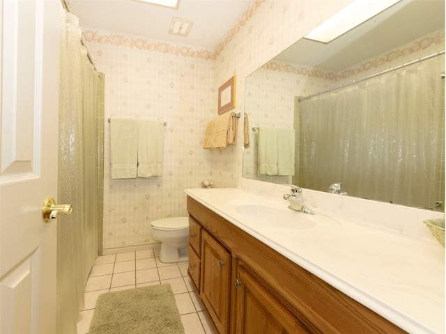 bathroom with vanity, toilet, walk in shower, and tile patterned flooring