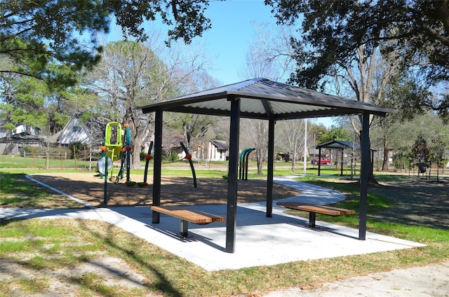 view of property's community featuring a playground and a lawn