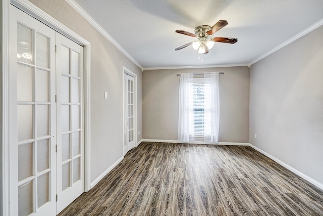 unfurnished room featuring crown molding, dark hardwood / wood-style floors, french doors, and ceiling fan