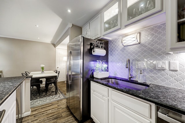 kitchen featuring tasteful backsplash, sink, white cabinetry, stainless steel dishwasher, and dark hardwood / wood-style floors