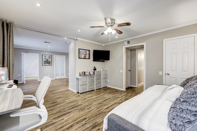 bedroom featuring ceiling fan, hardwood / wood-style flooring, and crown molding