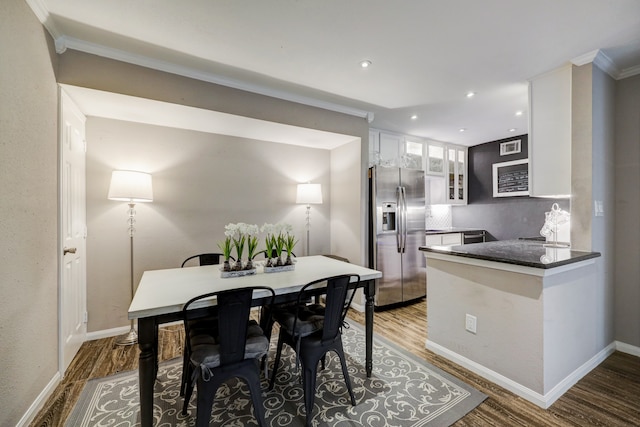 dining room with ornamental molding and hardwood / wood-style floors