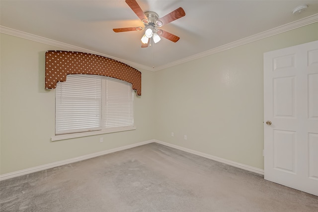 spare room with ornamental molding, carpet floors, and ceiling fan