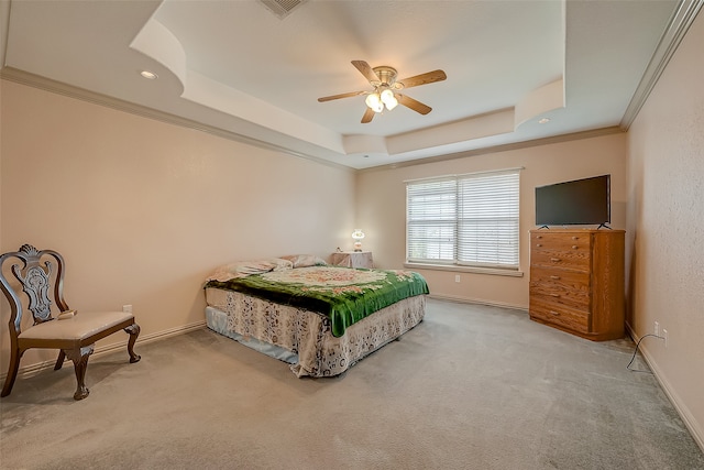 bedroom featuring ornamental molding, carpet floors, a tray ceiling, and ceiling fan