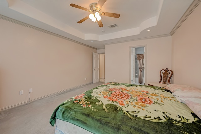 carpeted bedroom featuring crown molding, a tray ceiling, and ceiling fan