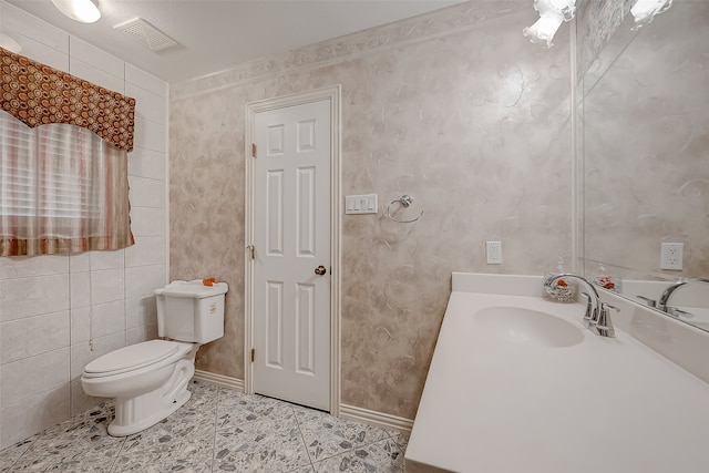 bathroom featuring vanity, toilet, and tile patterned flooring