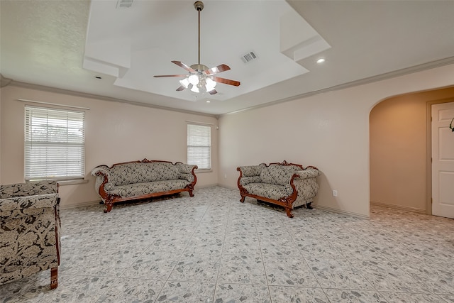 sitting room with ceiling fan, ornamental molding, a tray ceiling, and tile patterned flooring