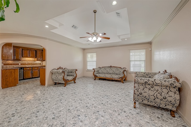 living room featuring ornamental molding, ceiling fan, and plenty of natural light