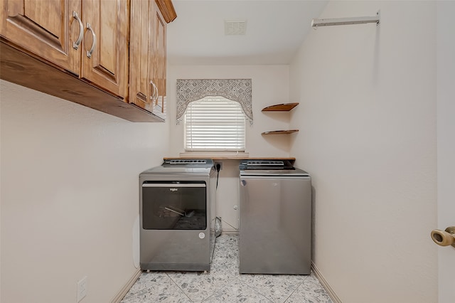 washroom with cabinets and independent washer and dryer