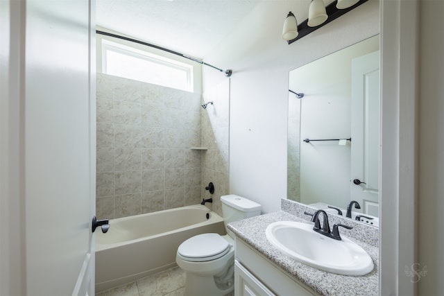 full bathroom with tile patterned floors, vanity, tiled shower / bath combo, and toilet