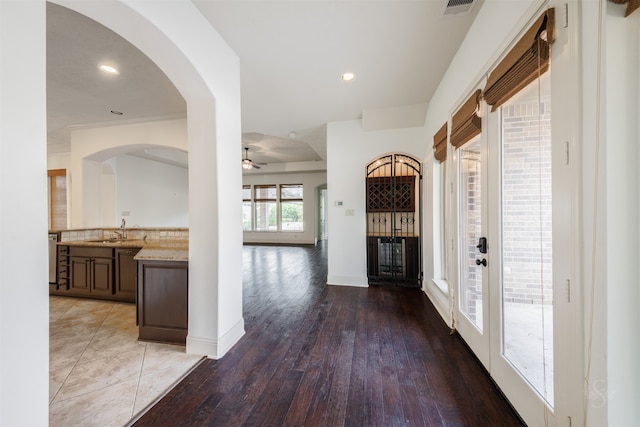 foyer entrance with ceiling fan, hardwood / wood-style floors, and sink