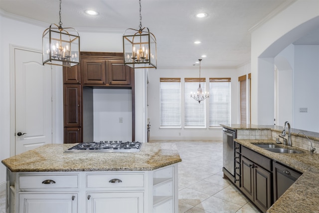 kitchen featuring dark brown cabinets, stainless steel appliances, sink, white cabinetry, and hanging light fixtures