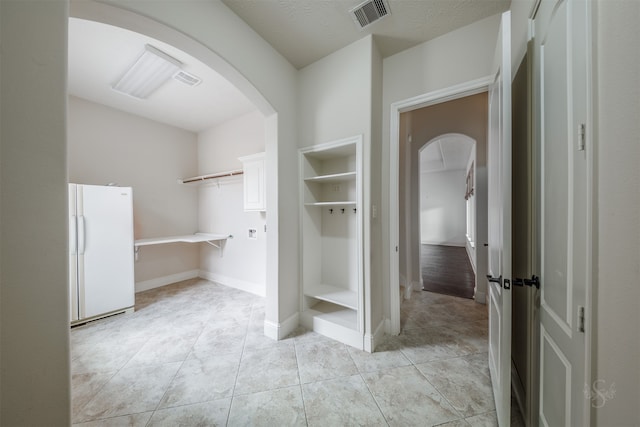 bathroom featuring tile patterned floors and a textured ceiling