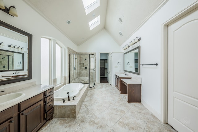 bathroom with vanity, shower with separate bathtub, high vaulted ceiling, and a skylight