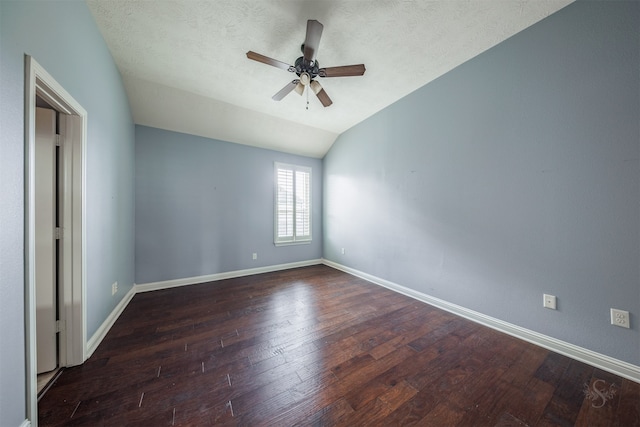 unfurnished bedroom with a textured ceiling, ceiling fan, lofted ceiling, and dark wood-type flooring