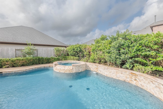 view of pool featuring an in ground hot tub